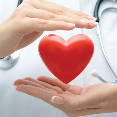 Female doctor with the stethoscope holding heart